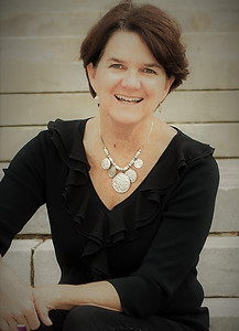 Nancy Fisher Crum, treasurer of the Art House's board. She is wearing a black shirt and a necklace.