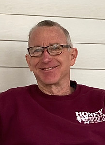 Bruce Page, member of the Art House's board. Bruce is wearing a maroon shirt and glasses.