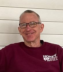 Bruce Page, member of the Art House's board. Bruce is wearing a maroon shirt and glasses.