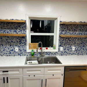 Hispanic themed backsplash with custom built floating shelves 