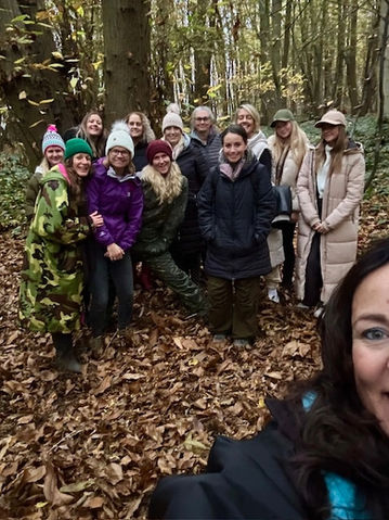 Forest bathing group gathering in woodland during a guided nature therapy session