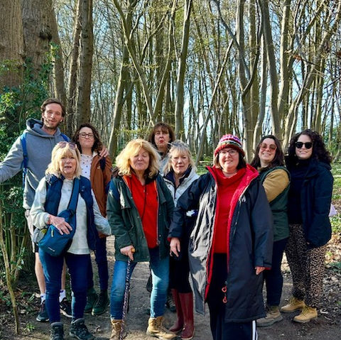 Forest bathing participants gathered together after a guided woodland experience