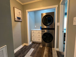 Stackable washer and dryer next to folding countertop.
