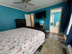 Master bedroom with large windows for natural light.