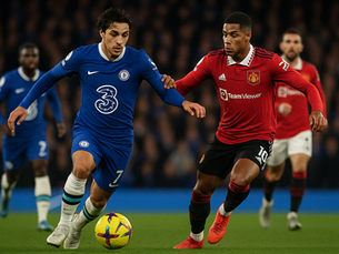 Two soccer players in blue representing Chelsea and in red representing Manchester United jerseys chase a ball on a field. Background blurred. Chelsea and Man United logos are visible on jerseys. Intense action.
