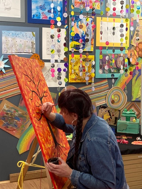 NDIS participant painting a tree
