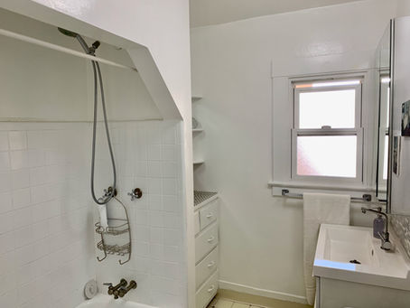 Bathroom with vanity and storage cabinet