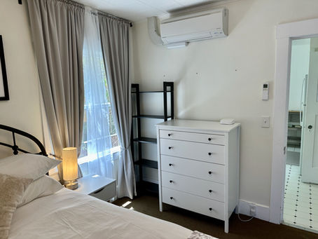 Bedroom 2, plenty of storage, dresser, bookcase, large window, night table, lamps, and linen