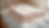 Close-up view of a soft, pastel-colored baby blanket folded neatly on a wooden crib
