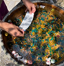 Close-up of a person washing hands at a traditional Kyoto purification basin.