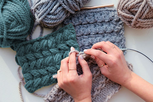 Closeup of person's hands knitting