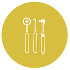 A round yellow icon showing a clipart of dental tools, such as mirror and probe.