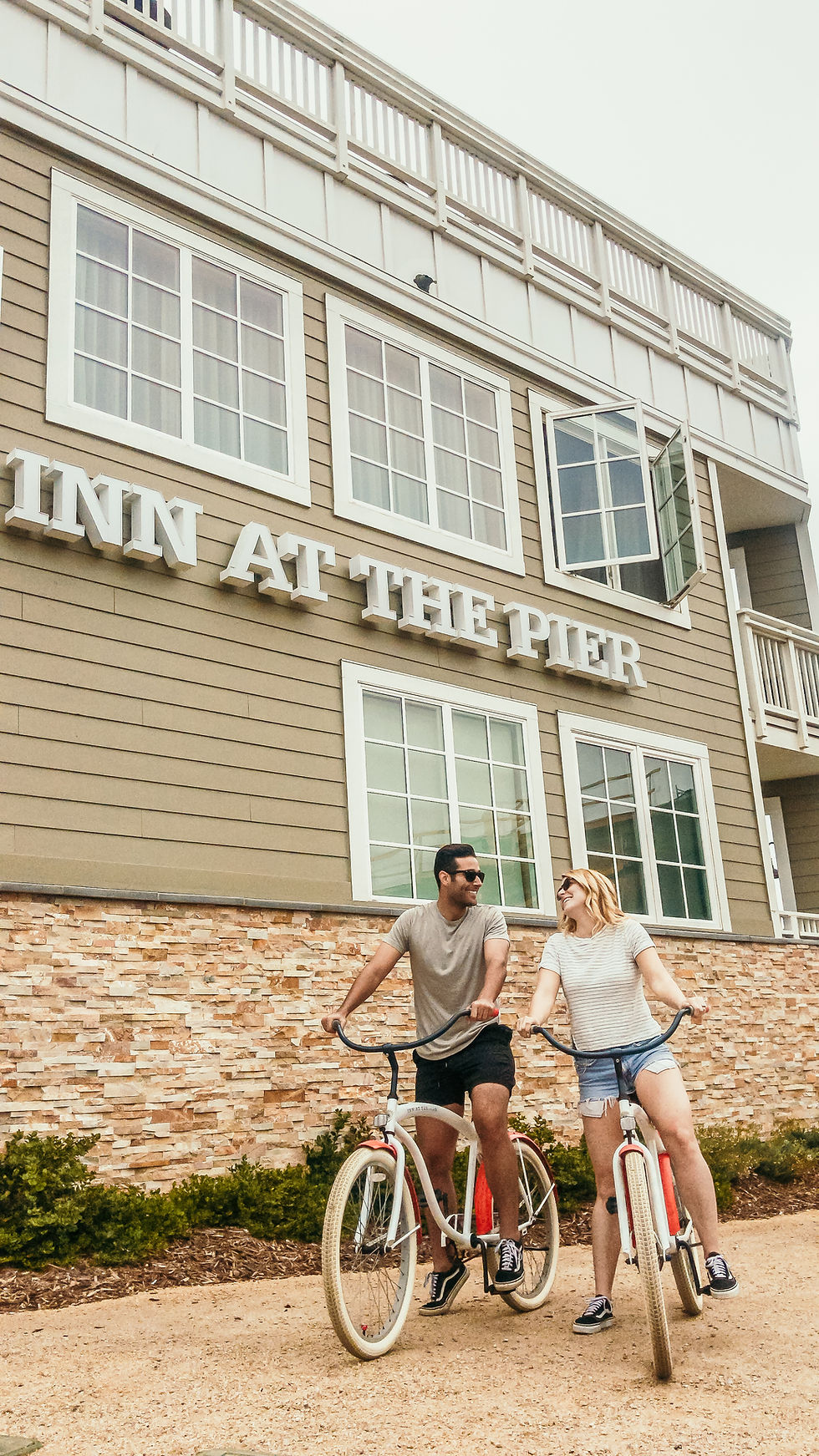 Couple biking at Inn at the Pier
