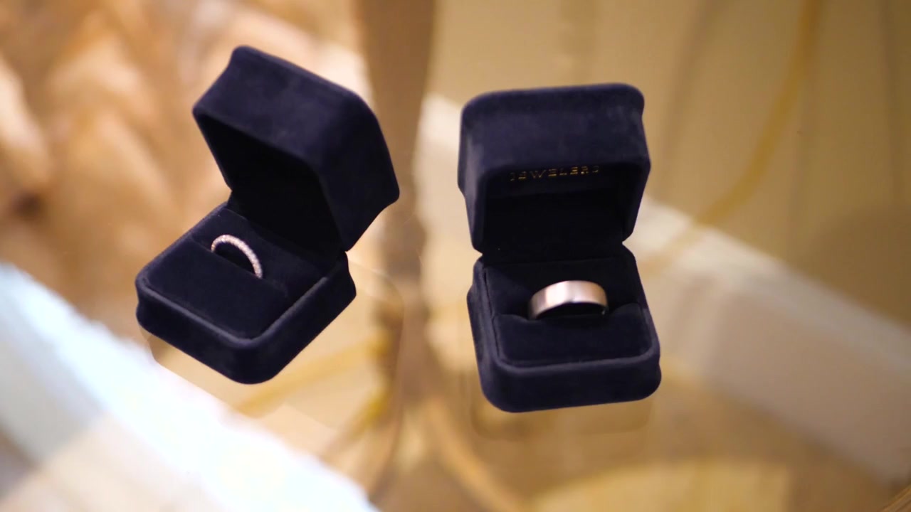 Wedding rings in navy presentation boxes from a Pozo Media wedding film