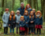 A cheerful group of redheaded family members enjoy a day in an enchanting Irish forest.