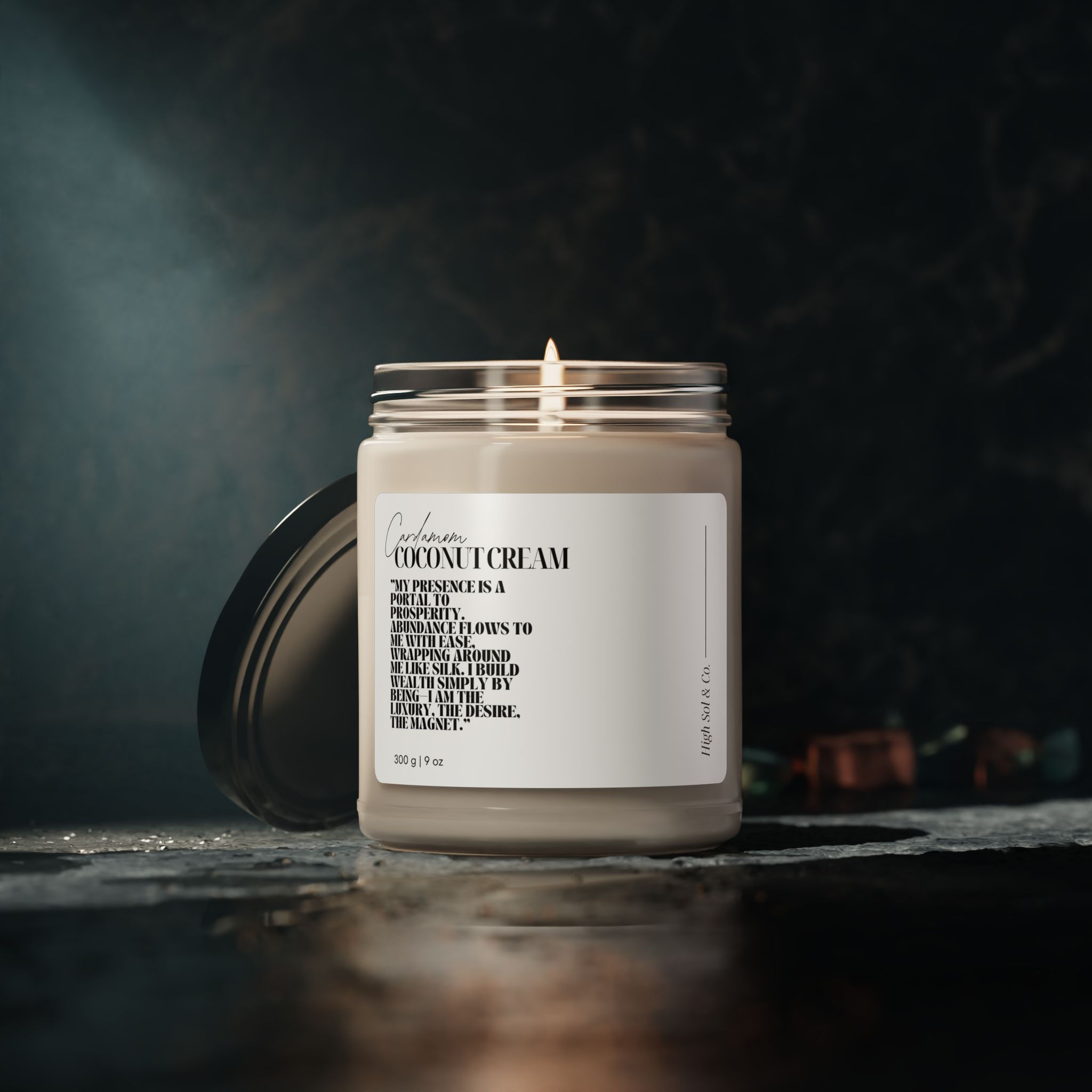 Luxury coconut cream soy candle in glass jar on dark reflective surface