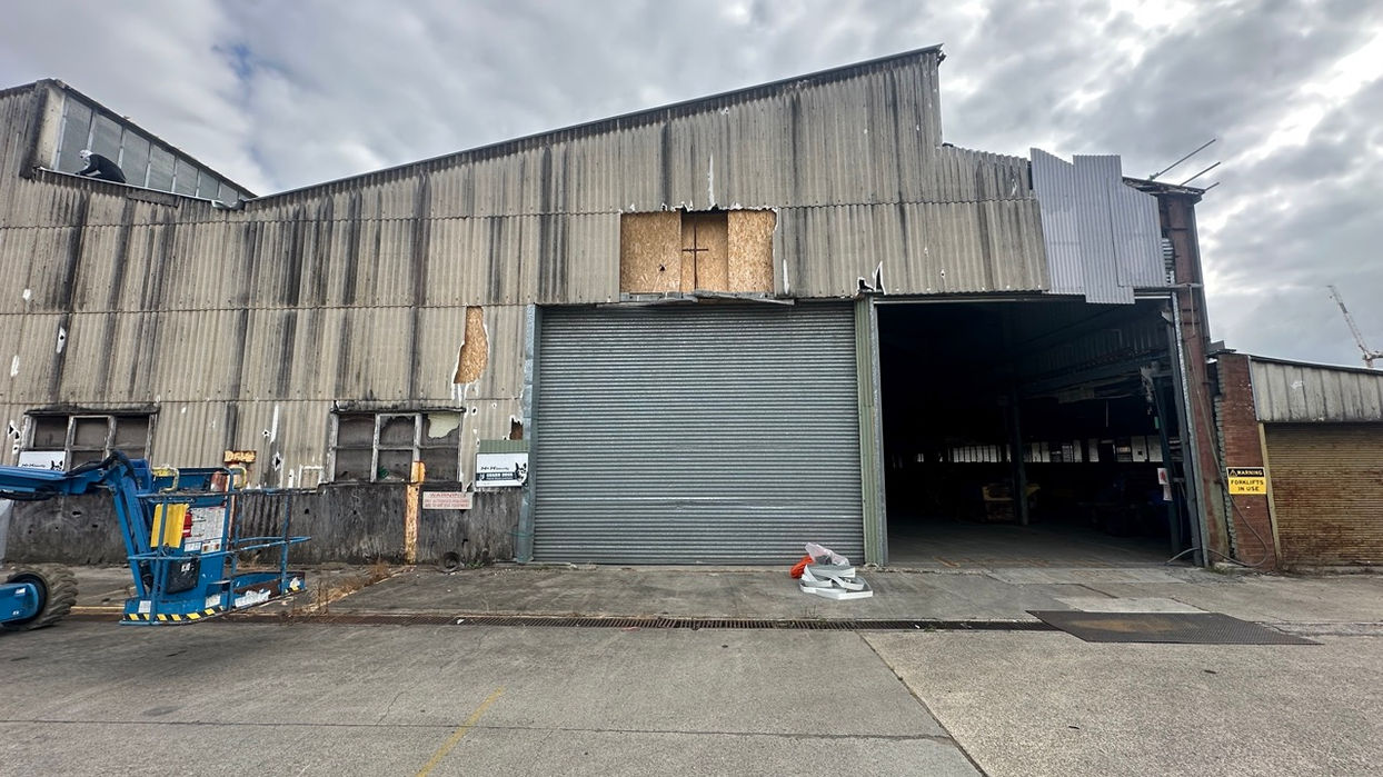 Existing asbestos wall cladding at Campbelltown Frames & Trusses warehouse before replacement
