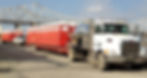 portable toilets on trailer with bridge in background