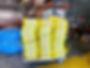 Multiple yellow web slings on a metal cart.
