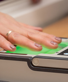 The process of scanning fingerprints during the check at border crossing. Female hand puts