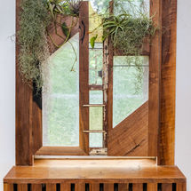 wood and stained glass privacy panel in bathroom with plants