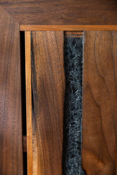 wood and metal side table with burnt edges and metal handles. Stained glass window.