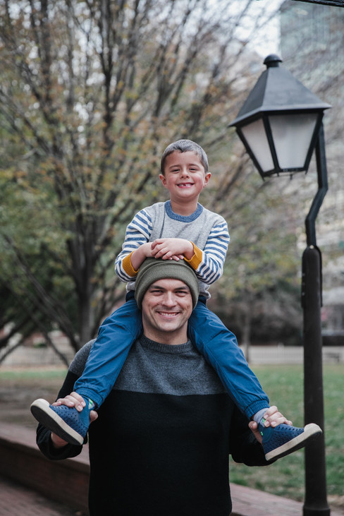Father and son in winter hats. Son on his shoulders in old city philadelphia