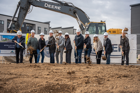 A group of constituents at a ceremonial groundbreaking shoveling dirt