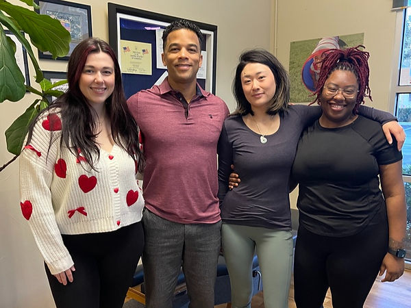 Sam, Dr. Rayman, Diana, and Tasha smile at the camera in the KeyStone Chiropractic office.