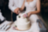 bride-groom-are-cutting-decorated-with-flowers-wedding-cake.jpg
