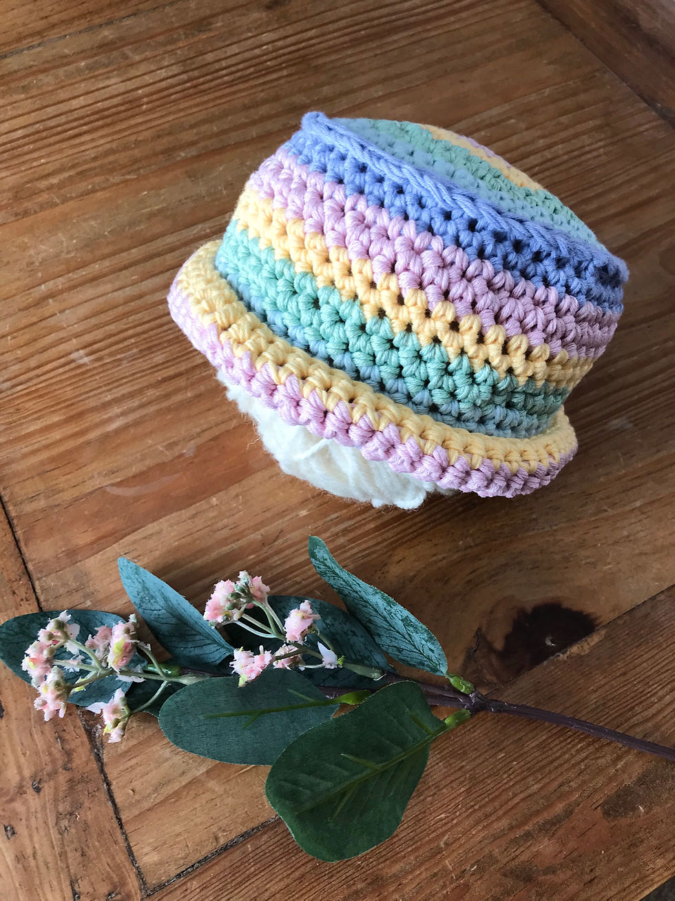 Crochet handmade baby boater hat in pastel rainbow stripe