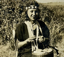 Woman holding traditional Native American cloth showcasing handmade pottery