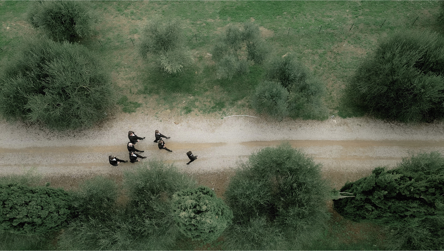 Guests walking through a Tuscan landscape during a luxury destination wedding weekend planned by AVPEvents