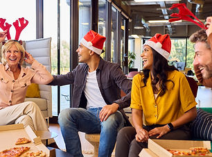 Staff Celebrating With Christmas Party And Meal In Office.jpg