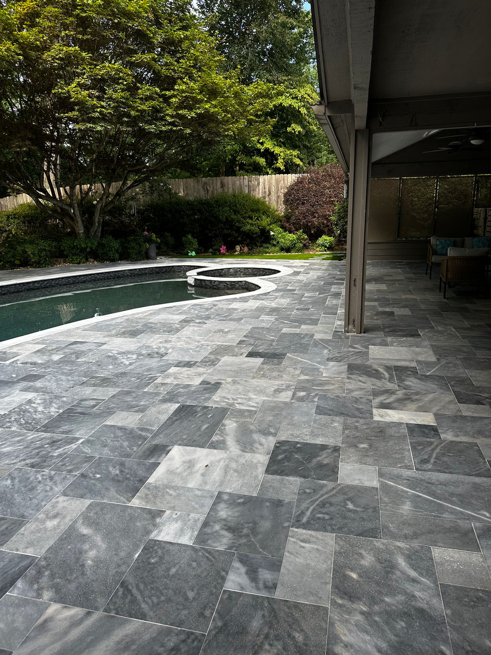 a patio with a swimming pool in the background