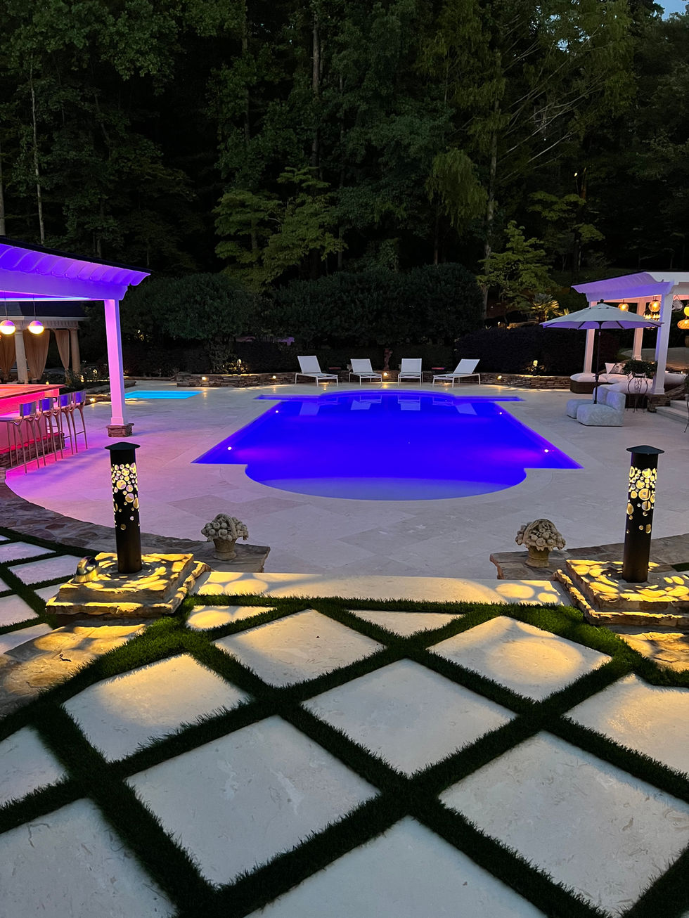 a large swimming pool is lit up at night