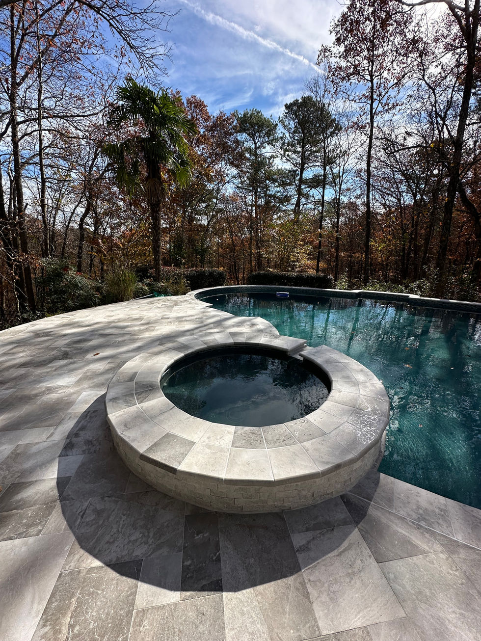 a hot tub sits next to a large swimming pool