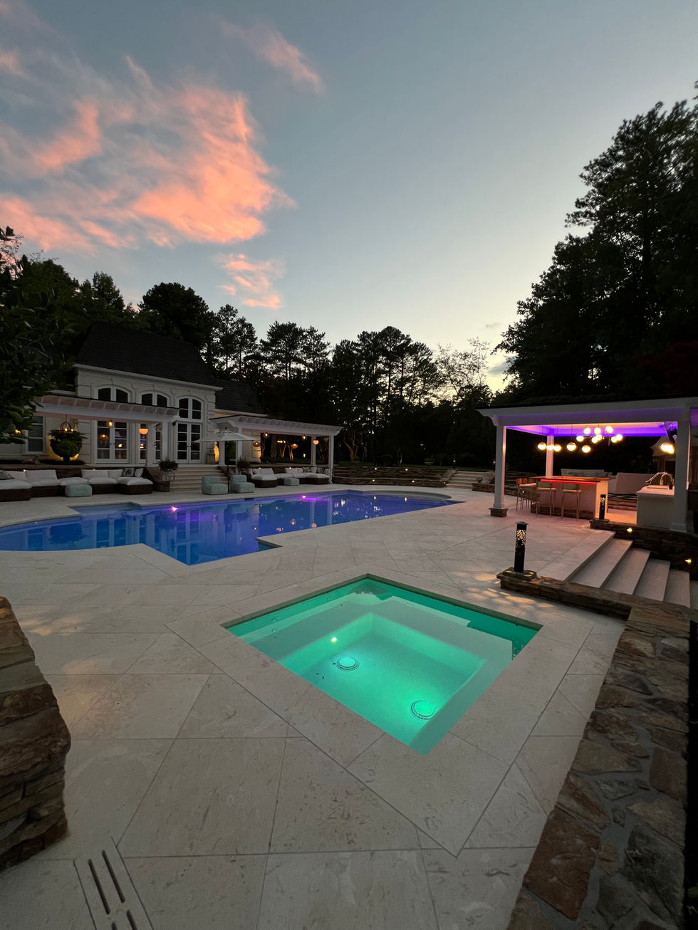 a large backyard with a swimming pool and a hot tub