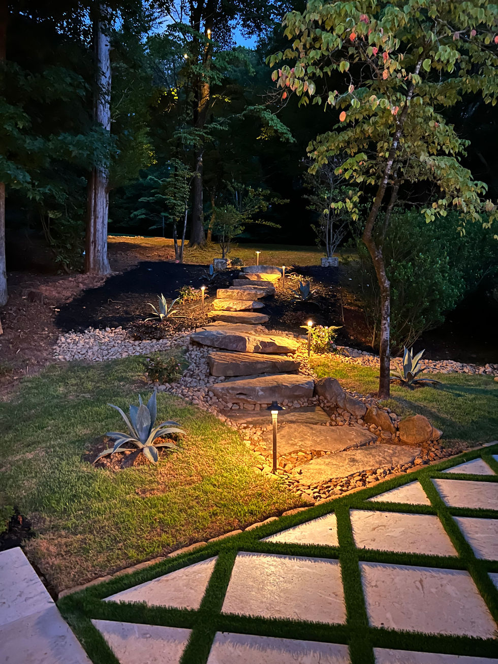 a stone walkway is lit up at night