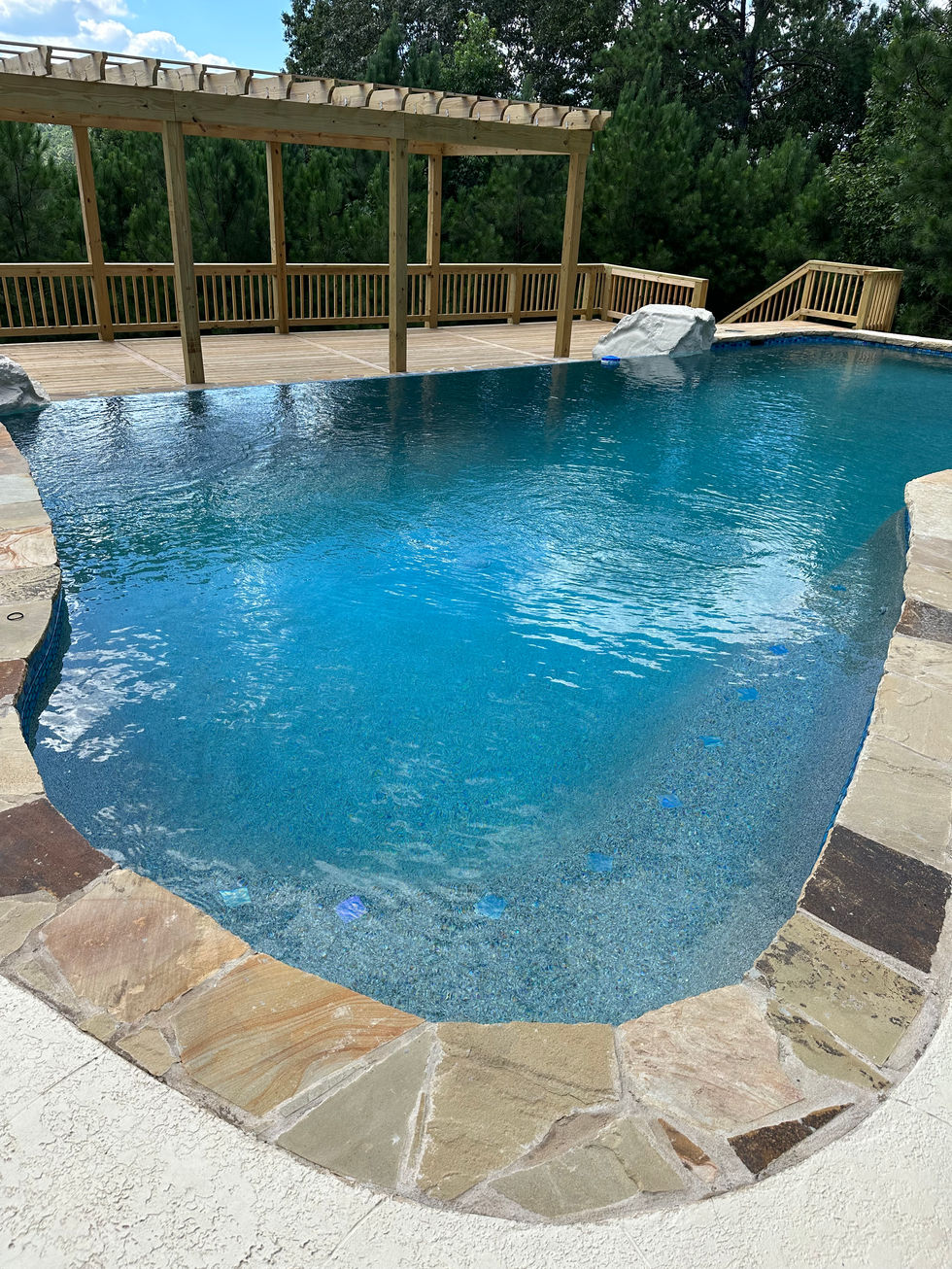 a large swimming pool with a wooden deck in the background