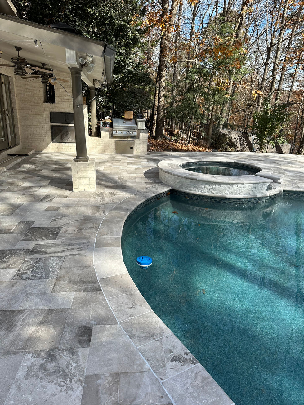 a swimming pool with a hot tub and a grill