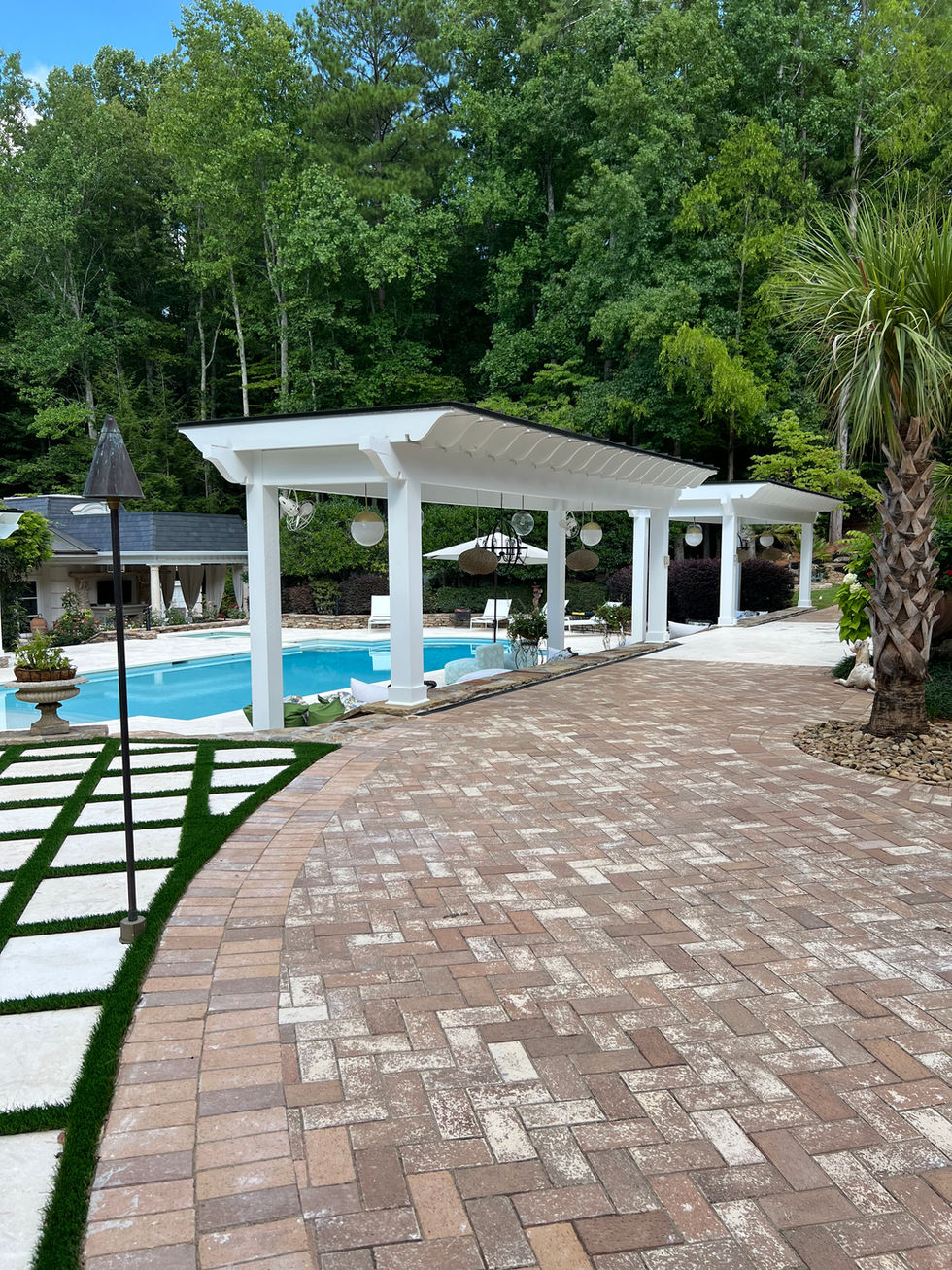 a large swimming pool with a white pergola over it