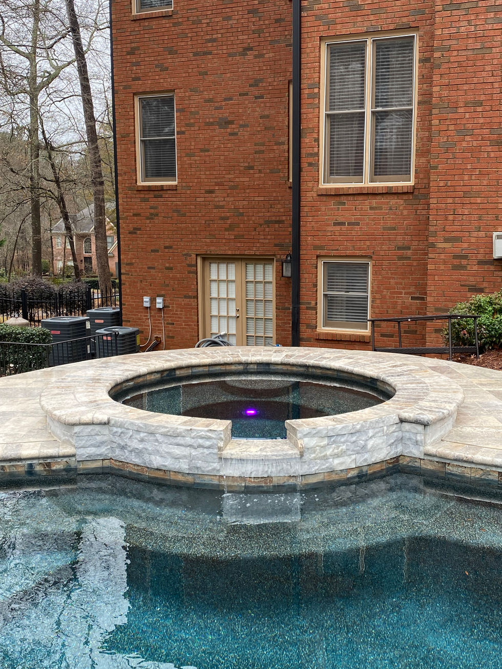 a brick house with a swimming pool in front of it