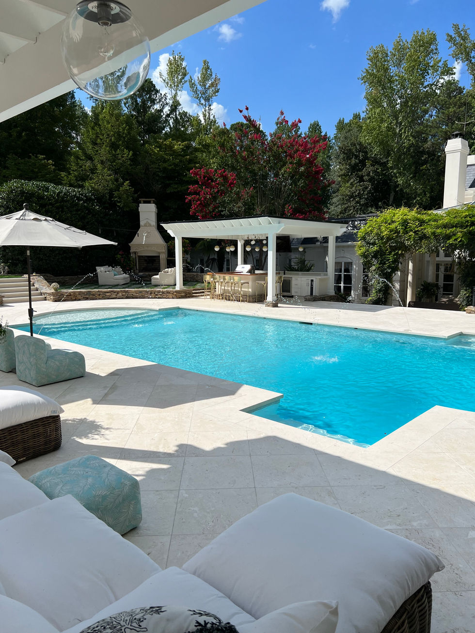 a large swimming pool with a bar in the backyard