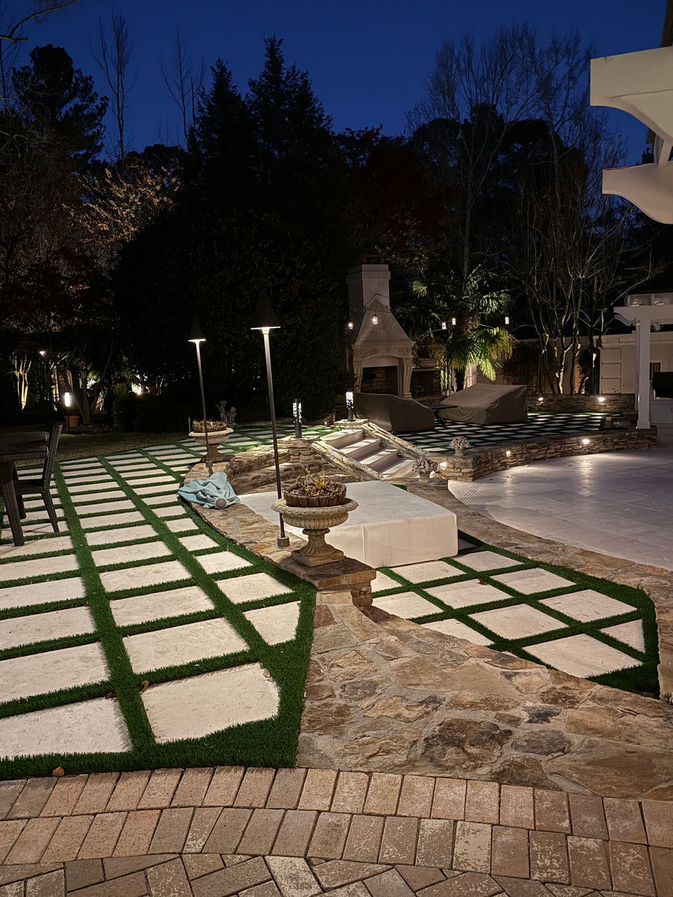 a patio area with a fireplace in the background