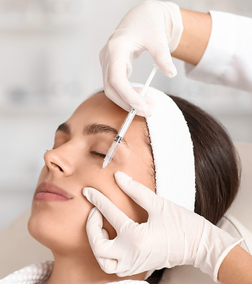 Young woman receiving cheek filler injection in beauty salon.jpg