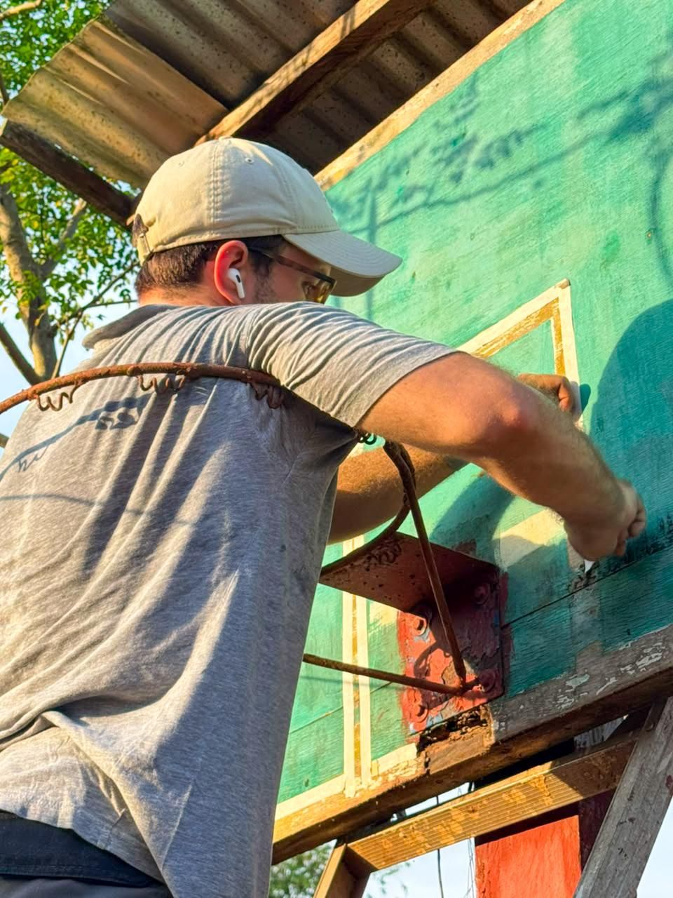 Alexander Riedl painting a wall at Pathway Homestay Libis in the evening light