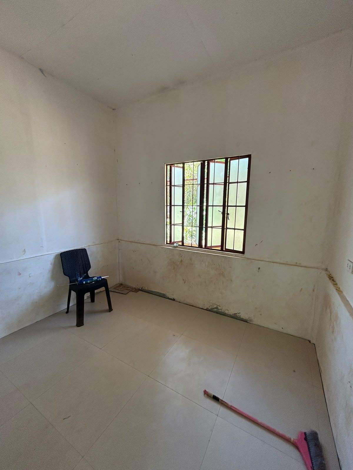 Second bedroom before the renovation, with a new floor already laid
