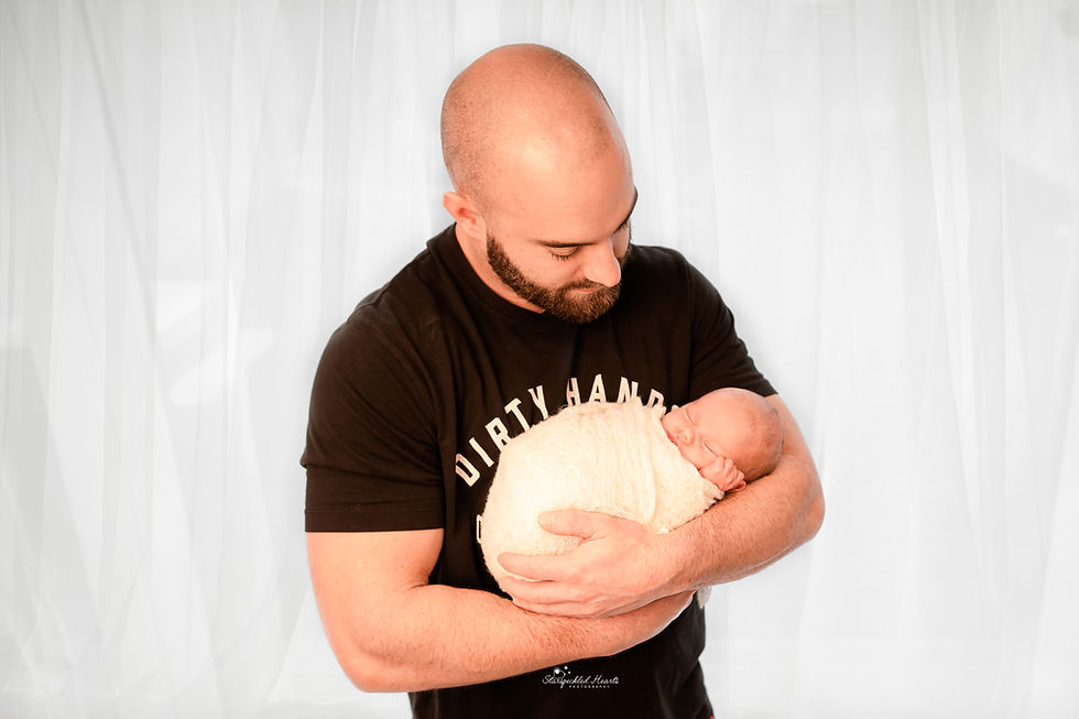 a man cradling his newborn baby girl