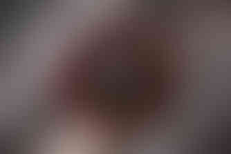 sleeping newborn boy lying in a nest of twigs with red berries